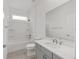 This full bathroom features a shower-tub and a grey vanity with quartz counters at 5894 Sw 77Th Ct, Ocala, FL 34481