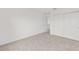 This bedroom has neutral carpet, base molding, a closet, and crisp white walls at 5894 Sw 77Th Ct, Ocala, FL 34481