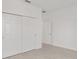 This bedroom features a large closet and bright white walls and wood-look tile floors at 5894 Sw 77Th Ct, Ocala, FL 34481