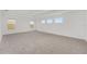 Bedroom with a tray ceiling, base molding, and three windows for ample natural light at 5894 Sw 77Th Ct, Ocala, FL 34481
