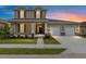Two story home with a 2 car garage, front porch with columns and landscaping at 5894 Sw 77Th Ct, Ocala, FL 34481