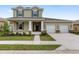 Two story home with a 2 car garage, front porch with columns and landscaping at 5894 Sw 77Th Ct, Ocala, FL 34481