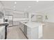 Open kitchen with granite counters, gray cabinets, and stainless steel appliances overlooking the living area at 5894 Sw 77Th Ct, Ocala, FL 34481