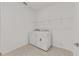 Bright laundry room features a washer, dryer, and storage shelving at 5894 Sw 77Th Ct, Ocala, FL 34481