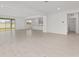 Open living room with tile flooring, leading to the kitchen at 5894 Sw 77Th Ct, Ocala, FL 34481