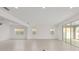 Spacious and naturally lit living room featuring tiled flooring and large windows at 5894 Sw 77Th Ct, Ocala, FL 34481
