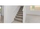 Carpeted staircase with white walls leading to the upper level of the home at 5894 Sw 77Th Ct, Ocala, FL 34481