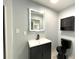 Modern bathroom with updated vanity, illuminated mirror, and black fixtures at 6134 Se Stetson Rd, Belleview, FL 34420