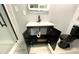 Bathroom featuring a new vanity with black fixtures and a black toilet at 6134 Se Stetson Rd, Belleview, FL 34420
