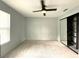Large bedroom featuring a ceiling fan, neutral carpet, window, and closet at 6134 Se Stetson Rd, Belleview, FL 34420