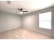 A bright bedroom with neutral carpet, ceiling fan, and a window for natural light at 6134 Se Stetson Rd, Belleview, FL 34420