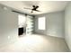 Bedroom featuring a ceiling fan, neutral carpet, and a sliding barn door at 6134 Se Stetson Rd, Belleview, FL 34420