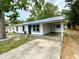 Charming home with a metal roof, fresh paint, manicured landscaping and covered parking at 6134 Se Stetson Rd, Belleview, FL 34420