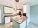 Beautiful kitchen featuring granite countertops, stainless steel appliances, island and new lighting at 6134 Se Stetson Rd, Belleview, FL 34420