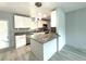 Beautiful kitchen featuring granite countertops, stainless steel appliances, island and new lighting at 6134 Se Stetson Rd, Belleview, FL 34420