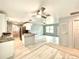 Updated kitchen and open living space featuring modern lighting, stainless appliances, and new ceiling fans at 6134 Se Stetson Rd, Belleview, FL 34420