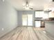 Kitchen-dining combo with stainless appliances, granite countertops, island, and sliding glass doors at 6134 Se Stetson Rd, Belleview, FL 34420
