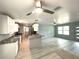 Updated kitchen and open living space featuring modern lighting, stainless appliances, and new ceiling fans at 6134 Se Stetson Rd, Belleview, FL 34420
