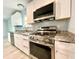 Gourmet kitchen with stainless appliances, granite countertops, island, and custom cabinetry at 6134 Se Stetson Rd, Belleview, FL 34420