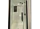 Modern glass-enclosed shower with black fixtures and white tile at 6134 Se Stetson Rd, Belleview, FL 34420