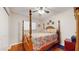 Nice bedroom featuring a wooden four poster bed frame and ceiling fan at 6468 Sw 107Th Pl, Ocala, FL 34476