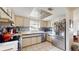 Well-lit kitchen featuring stainless steel appliances, tile backsplash, and unique artistic ceiling feature at 6468 Sw 107Th Pl, Ocala, FL 34476