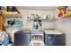 Well-organized laundry room with modern washer and dryer, ample shelving for storage at 6468 Sw 107Th Pl, Ocala, FL 34476
