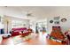 Inviting living room featuring wood floors, ceiling fan, and comfortable seating area at 6468 Sw 107Th Pl, Ocala, FL 34476