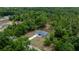 An aerial view showcases this attractive home nestled among lush trees and situated on a sprawling lot at 7299 Sw 202 Ct, Dunnellon, FL 34431