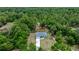 An aerial view showcasing the home's location within a serene wooded area at 7299 Sw 202 Ct, Dunnellon, FL 34431