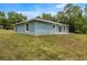 A view of the backyard showcasing the home's exterior and outdoor space at 7299 Sw 202 Ct, Dunnellon, FL 34431