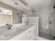Bathroom featuring double sinks, a large mirror and marble accented shower with black trim at 7299 Sw 202 Ct, Dunnellon, FL 34431