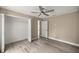 Bedroom showcases a ceiling fan, vinyl floors, and a closet at 7299 Sw 202 Ct, Dunnellon, FL 34431
