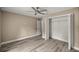 Bedroom showcases a ceiling fan, vinyl floors, and a closet at 7299 Sw 202 Ct, Dunnellon, FL 34431