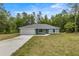 Charming single-story home featuring a well-manicured lawn, attached garage, and freshly painted exterior at 7299 Sw 202 Ct, Dunnellon, FL 34431