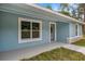 Inviting front porch and entryway, featuring a large window that fills the home with natural light at 7299 Sw 202 Ct, Dunnellon, FL 34431
