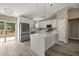 A beautifully designed kitchen features modern appliances, stylish lighting, and a seamless flow to the outdoors at 7299 Sw 202 Ct, Dunnellon, FL 34431