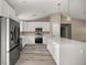 Gleaming white kitchen featuring an island, stainless steel appliances, and quartz countertops at 7299 Sw 202 Ct, Dunnellon, FL 34431