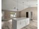 Spacious kitchen island opens up into an airy living area with modern lighting at 7299 Sw 202 Ct, Dunnellon, FL 34431