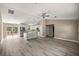 Bright and airy open-concept living space features wood-look floors, modern lighting, and a spacious kitchen at 7299 Sw 202 Ct, Dunnellon, FL 34431