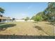 Spacious backyard with lush greenery, white fence, and mature trees offering shade at 7475 Se 105Th Pl, Belleview, FL 34420