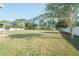 Expansive backyard featuring a well-maintained lawn, privacy fence, and mature trees at 7475 Se 105Th Pl, Belleview, FL 34420