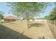 Generously sized backyard with a mix of grass and shade, enclosed by a wire and privacy fence at 7475 Se 105Th Pl, Belleview, FL 34420