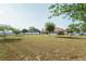 Large backyard featuring mature trees and a white fence, offering privacy and space at 7475 Se 105Th Pl, Belleview, FL 34420