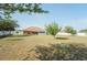Large, private backyard with mature trees, white privacy fence, and partial view of the home's patio at 7475 Se 105Th Pl, Belleview, FL 34420