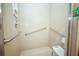 Accessible bathroom featuring grab bars and a convenient shower seat at 7475 Se 105Th Pl, Belleview, FL 34420