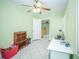 Bedroom with ceiling fan, showing view to the kitchen, offering versatility as a home office at 7475 Se 105Th Pl, Belleview, FL 34420