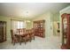 Elegant dining room with a chandelier, large table, and hutch for storage and display at 7475 Se 105Th Pl, Belleview, FL 34420