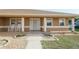 Charming home's front porch features white columns, rocking chairs, and minimal landscaping at 7475 Se 105Th Pl, Belleview, FL 34420