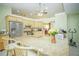 Bright and spacious kitchen with granite countertops, stainless steel appliances, and breakfast bar seating at 7475 Se 105Th Pl, Belleview, FL 34420